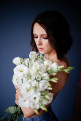Beautiful girl with a bouquet flowers.