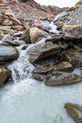 Cascades with rocks near the Matterhorn on a cloudy day
