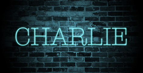 Fototapeta na wymiar first name charlie in blue neon on brick wall