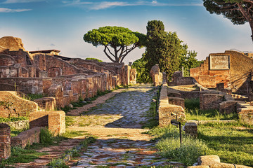 Archaeological Roman ruin street view in Ostia antica, a beautiful travel archaeology destination with well preserved ancient Rome ruins in ancient Ostia in Rome - Italy