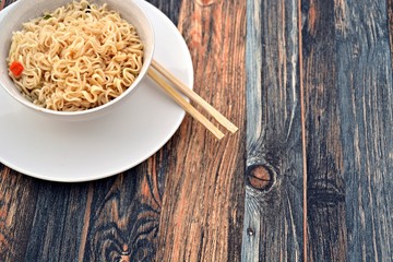 chinese instant noole soup in a bowl on a wooden table