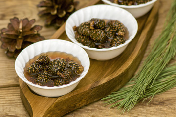tasty jam made from fir cones in white cups
