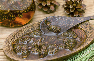 delicious jam of young fir cones in a wooden Cup and a wooden spoon