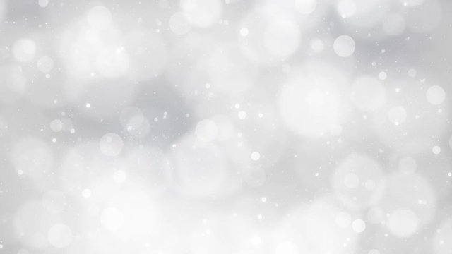 Beautiful silver colored bokeh with falling snow background.