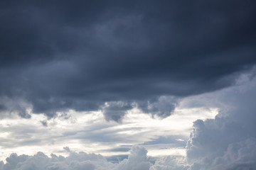 The sun shines on the sky from airplane, View on flight, bird  eye view.Over the Clouds. Fantastic background with clouds and mountain peaks
