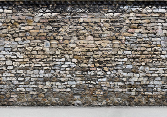 Old brown  stone wall with part of the road. Horizontal Seamless pattern.