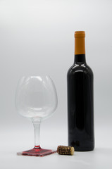 bottle of wine with a cork and glass