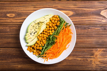 Buddha bowl with avocado , cucumber , carrot and chickpea