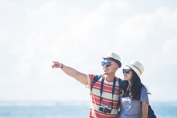 young backpacker with his partner pointing at something during s