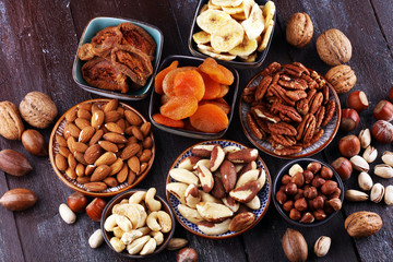 dried fruits and assorted nuts composition on rustic table
