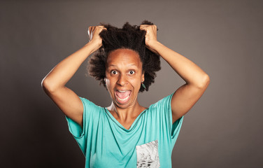 black woman screaming on a gray background