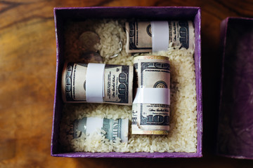 top view on a beautiful box for newlyweds with rice grains, coins and money