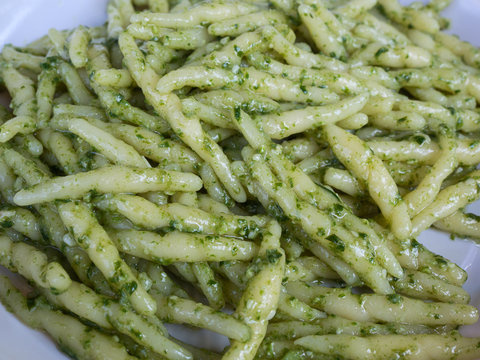 closeup of trofie al pesto: handmade pasta with basil sauce