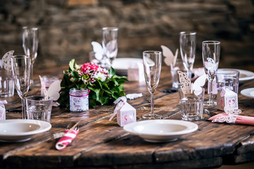 Wedding preparation - decorated wedding table settings with empty glasses and plates