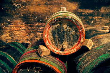 Barrel with a bung in the wine cellar. Red and green hoops.