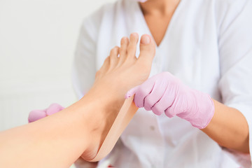 Obraz na płótnie Canvas Patient on medical pedicure procedure visiting podiatrist.Podologic polymer gel plates.Protecting the skin ulceration.Bedsore prevention.Foot treatment in SPA salon.Podiatry clinic.