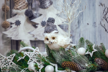 Beautiful magic house in Christmas decorations with a toy owl in hat
