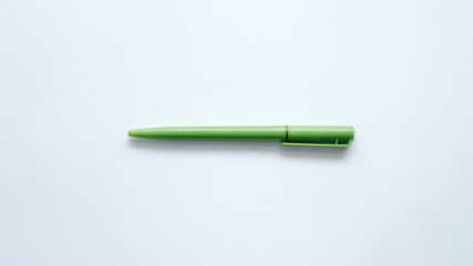 green pen on white background