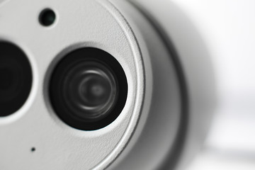 White security cctv dome type camera close-up. Lens and ir.