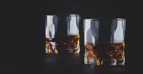 Bourbon in glass, american corn whiskey, dark bar counter, selective focus © 5ph