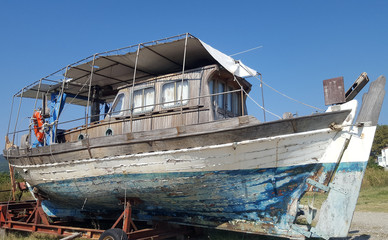 Fototapeta na wymiar Old ruined fishing boat awaiting restoration