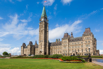 The Center Block and the Peace Tower in Parliament Hill, Ottawa, Canada. Center Block is home to the Parliament of Canada - obrazy, fototapety, plakaty