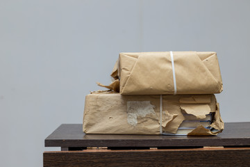 new books wrapped in brown paper on the table