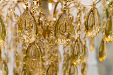 Close the crystal of modern chandelier, it is a branched decorative lamp, designed for installation on ceilings