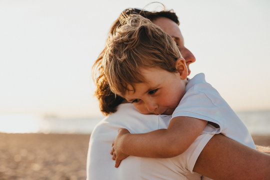 French Pregnant Mother And Her Little Boy on The Normandy Beach At Sunset