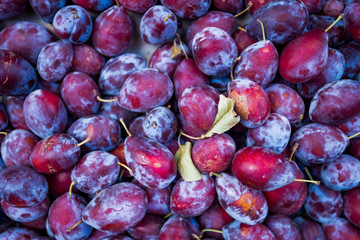 Ripe juicy plums as background