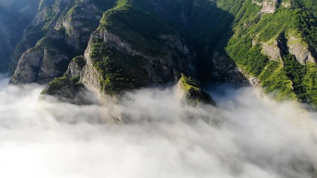 Aerial view of gorgeous Vorotan canyon covered with fog, Armenia