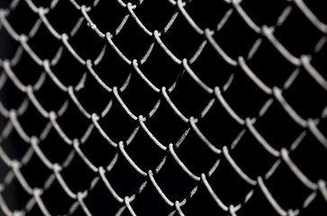 Metal fence on a black background