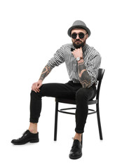 Portrait of handsome hipster in stylish outfit on white background