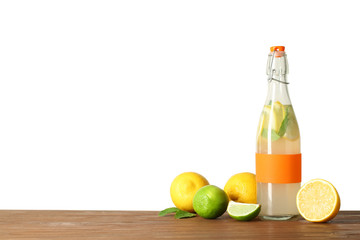 Bottle with natural lemonade on table against white background
