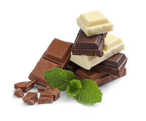 Different kinds of chocolate with mint on white background