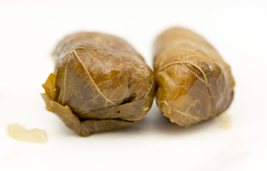 dolma, stuffed grape leaves on a white background