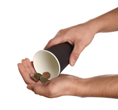 Poor man holding cup with coins on white background, closeup