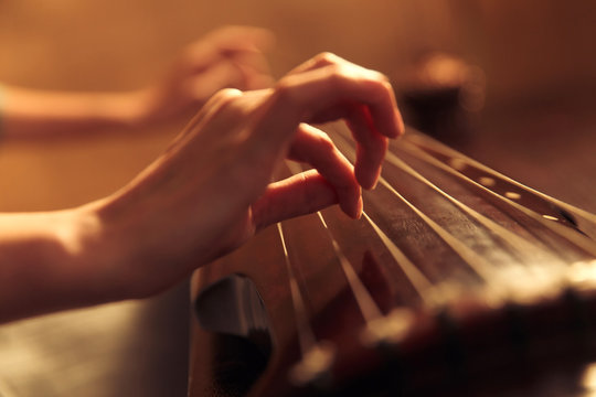 Young woman playing the lyre