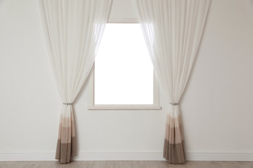 White wall with modern window and curtains indoors. Living room interior