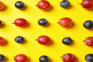 Fresh ripe juicy grapes on yellow background, top view