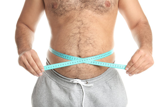Overweight man with measuring tape on white background, closeup