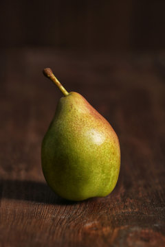 Tasty ripe green pear on wooden background