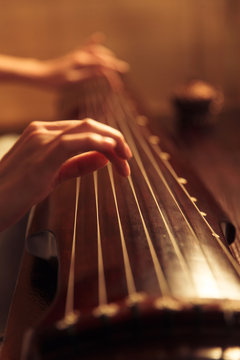 Young woman playing the lyre