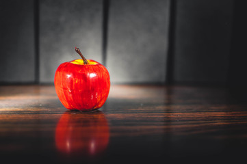 red apple on wooden table
