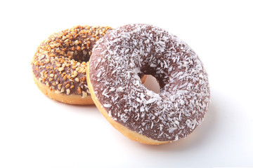 Assorted doughnuts in the glaze, colorful sprinkles and nuts on a white background.