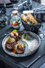 Grilled steak meat with foie gras, shrimp, cheese and glass of red wine
