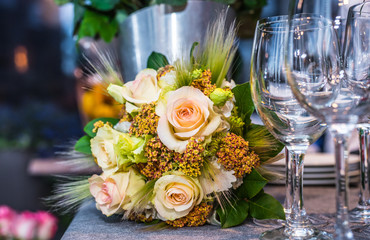 Beautiful flowers on the table with empty wine glasses