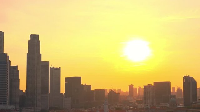 Abstract cityscape with skyscrapers of Marina Bay Financial Centre against spectacular sundown on background. Buildings illuminated by light of setting sun. Singapore