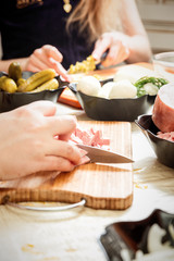 preparing russian salad 'Olivier', chopping the sausage