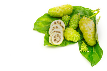 Noni fruit with green leaves on white background.